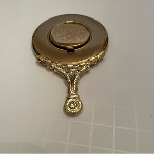 Vintage miniature gold hand mirror with small compartment for a picture